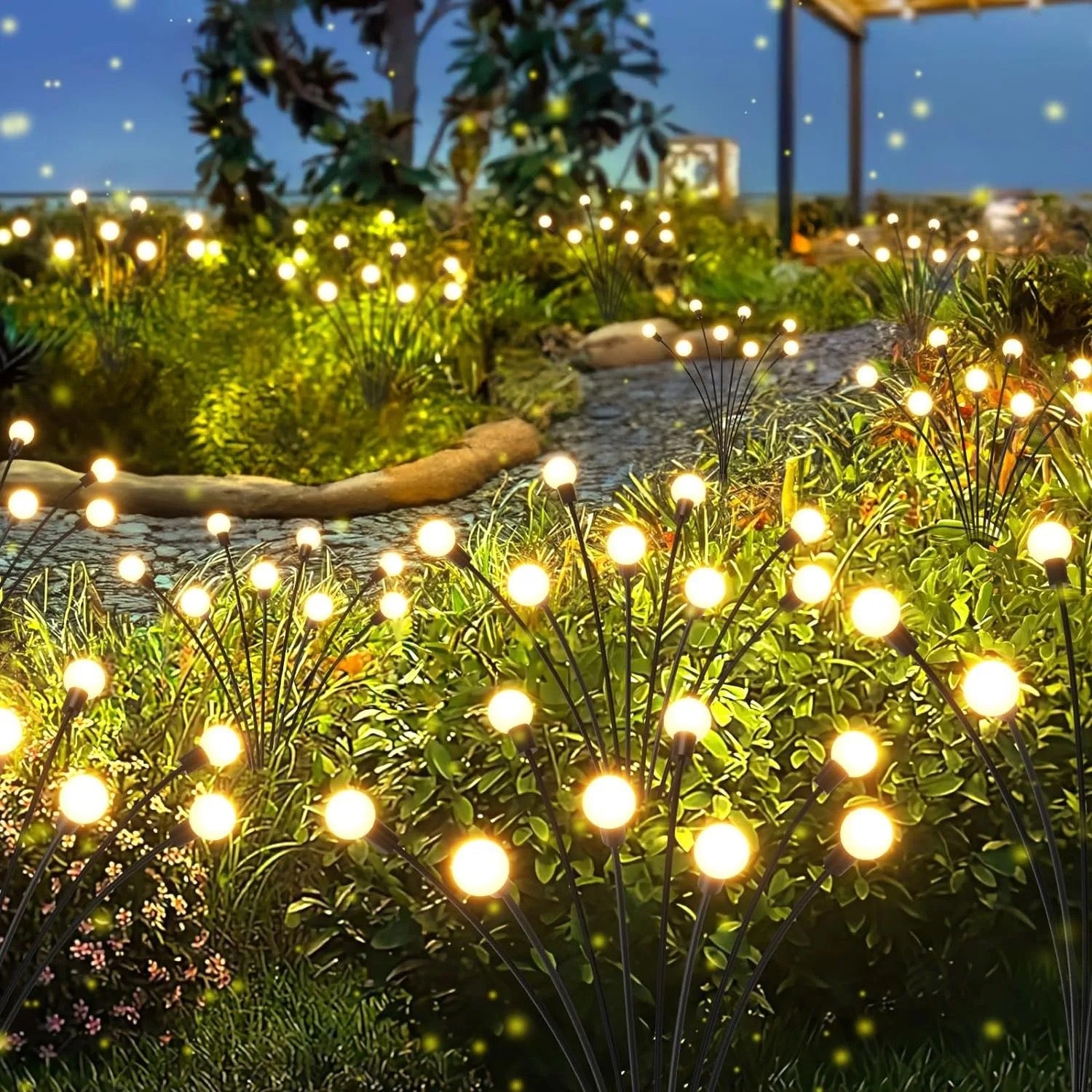 Firefly lights lining a garden path after sunset