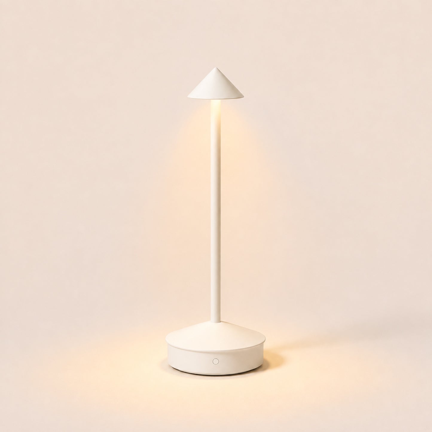 The Wren cordless table lamp in Soft White, lit, on warm porcelain background